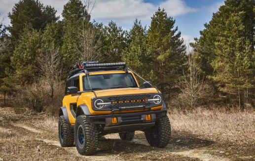 EV off-roading vehicle navigating a rugged trail in nature.