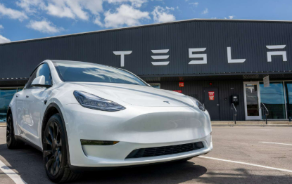 Tesla Sales electric vehicle on display at an auto show.